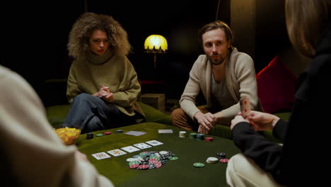 group of friends playing poker sitting on the couch in the living room 13