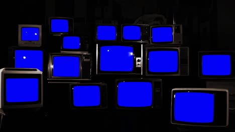 stacks of retro tvs turning on and off blue chroma screens. you can replace blue screen with the footage or picture you want. you can do it with “keying” effect in after effects. 4k resolution.