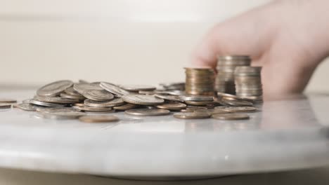 Various-Coin-Piles-spinning-in-frame