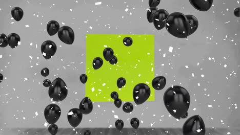 Confetti-falling-and-multiple-black-balloons-floating-over-green-memo-note-on-grey-background