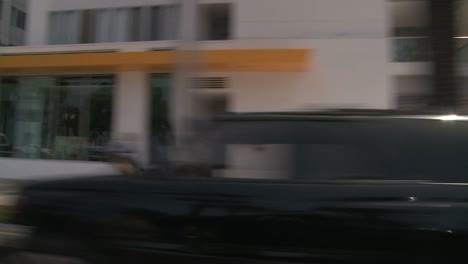 a car travels along a street in santa monica california as seen through the side window 6