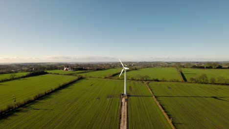 wind turbines and agricultural fields on a summer day - energy production with clean and renewable energy - aerial shot, staffordshire