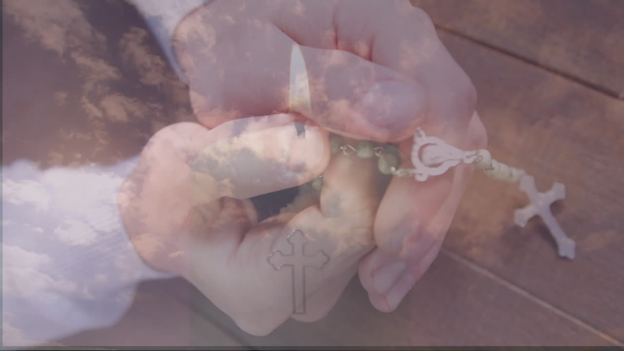 Man holding green-beaded rosary and igniting lighter in health guide, with animated cloud overlay