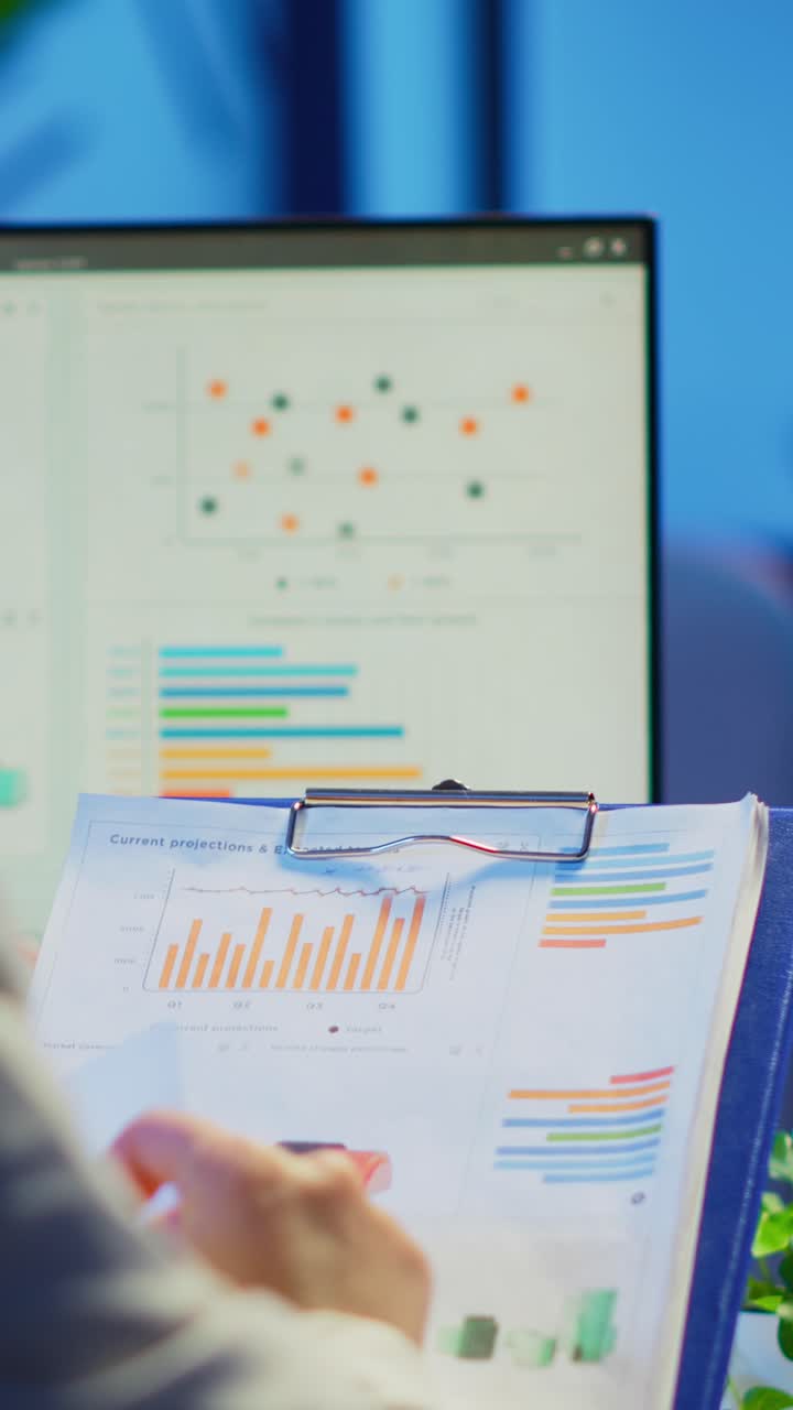 Vertical video: Close up of business woman holding clipboard with graphics