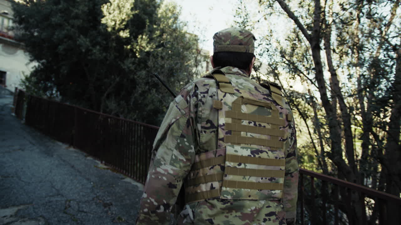 Soldier Alone Climbs An Uphill Road During A Mission