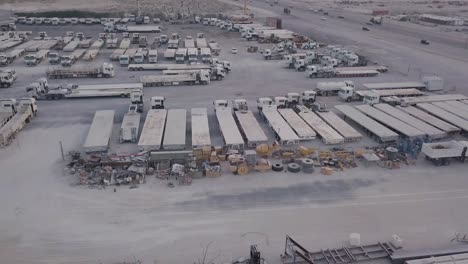 car driving through industrial vehicle yard aerial footage