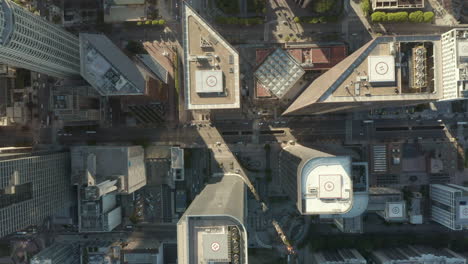 Downtown-Area-of-big-city-view-on-main-road-through-skyscrapers-with-little-car-traffic-due-to-Covid-19-Coronavirus-Pandemic-Lockdown-restrictions,-Aerial-Birds-Eye-Overhead-View