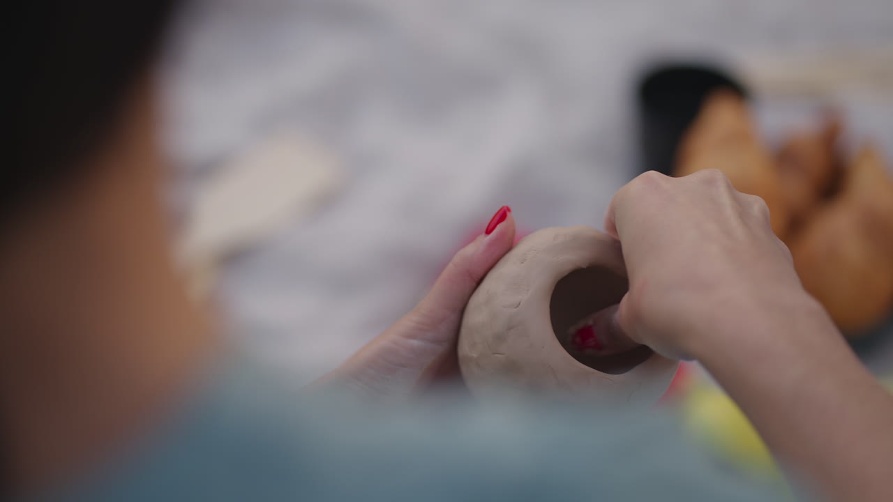 Women sculpt from clay in nature outdoors in the park. Creativity general hobbies women's group classes training in clay modeling. Close-up