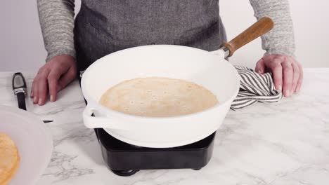 making crepes in a small frying pan