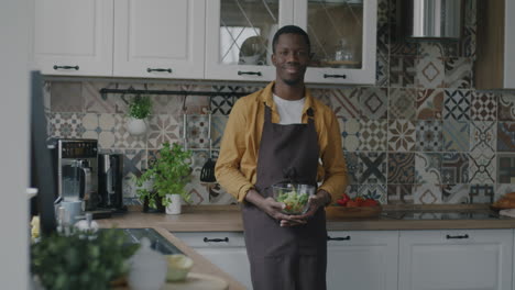 man preparing a salad in a kitchen