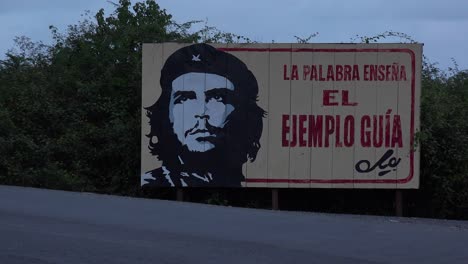 communist propaganda billboards line a road in cuba