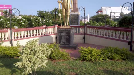 a tilt view of mahatma gandhi statue known as the father of the nation for his fight against the british for the freedom of india at mysuru cityscape   in 4k resolution.