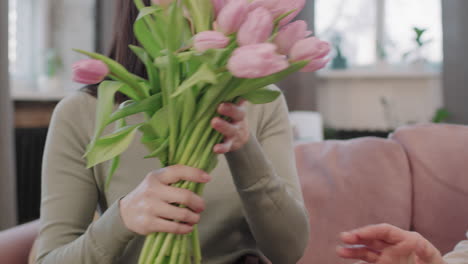 a bouquet of tulips between two women