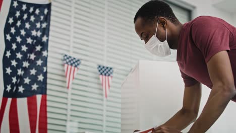 Low-angle-view-video-of-black-man--voting-in-face-mask