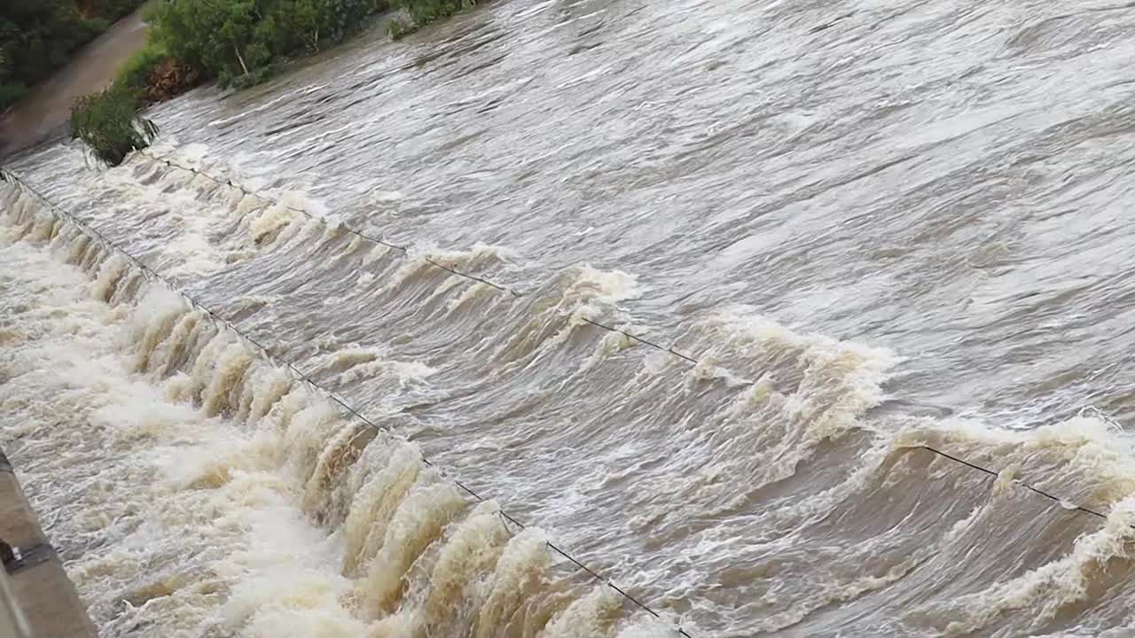River flooding over a foot bridge
