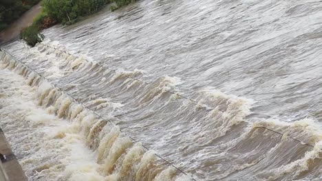 river flooding over a foot bridge