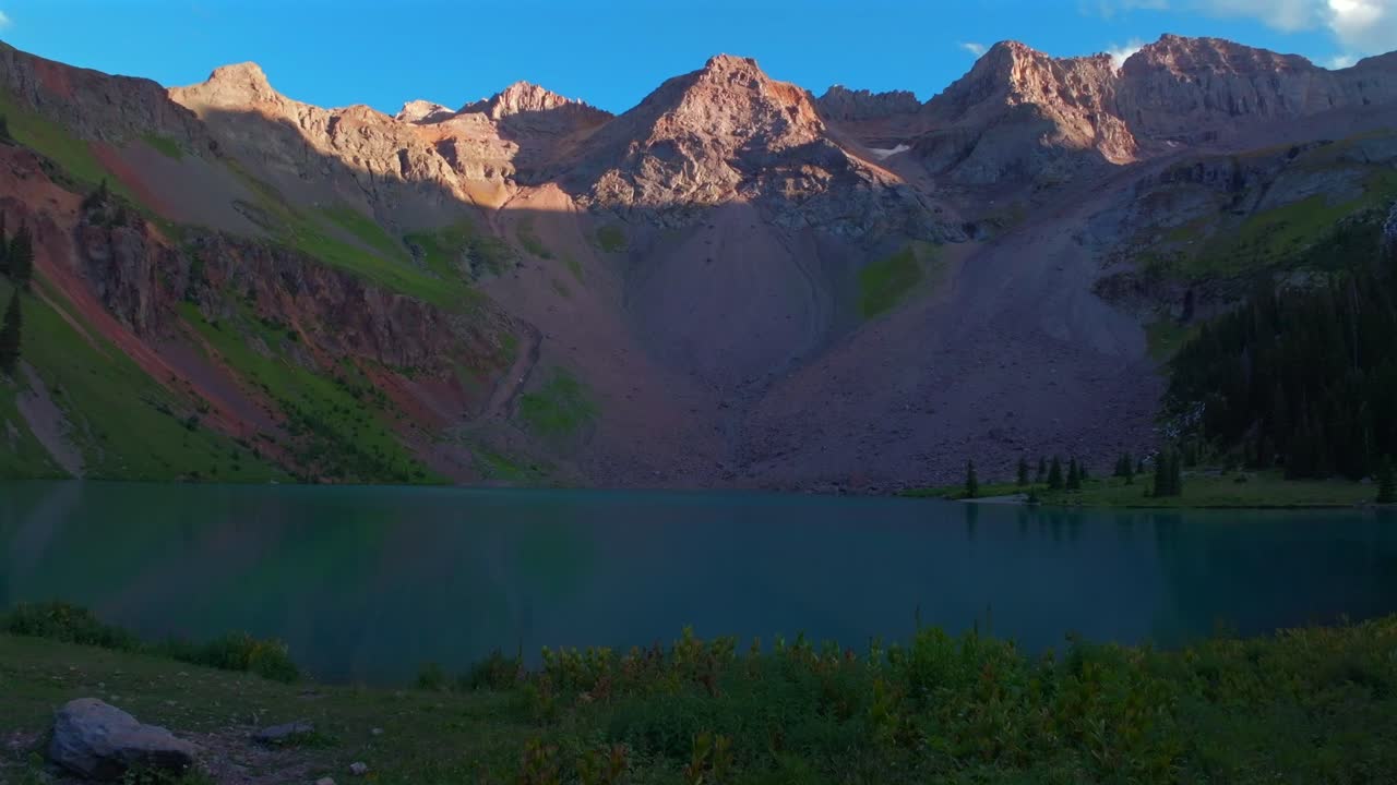 Sunset hiking trail Lower Blue Lakes wildflowers landscape Mount Sneffels Wilderness summer Ridgway Telluride Colorado Rocky Mountains Uncompahgre National Forest San Juan Dallas Range forward pan up