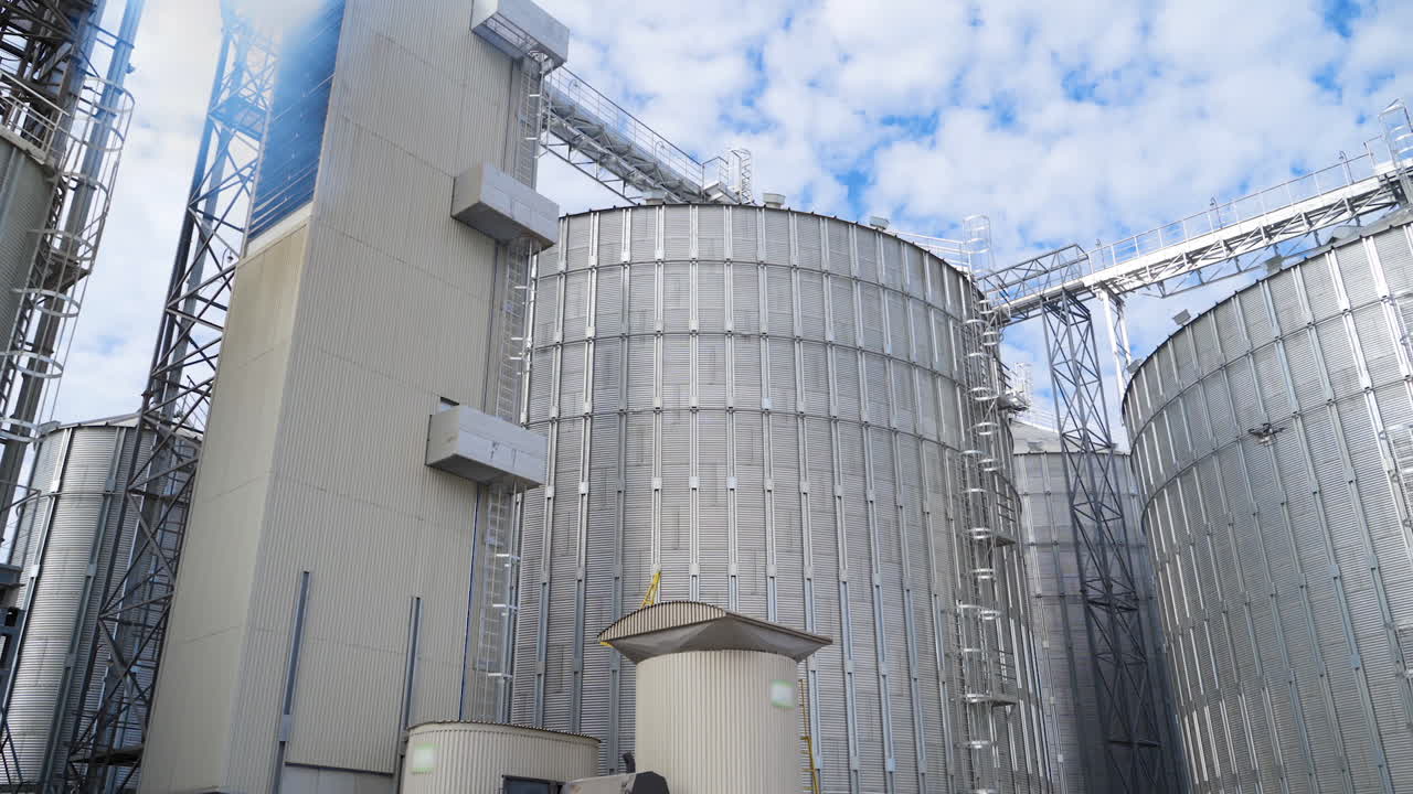 Exterior of modern industry. Large grain elevators for storing and processing agricultural products. Innovative hangar premises of a factory.