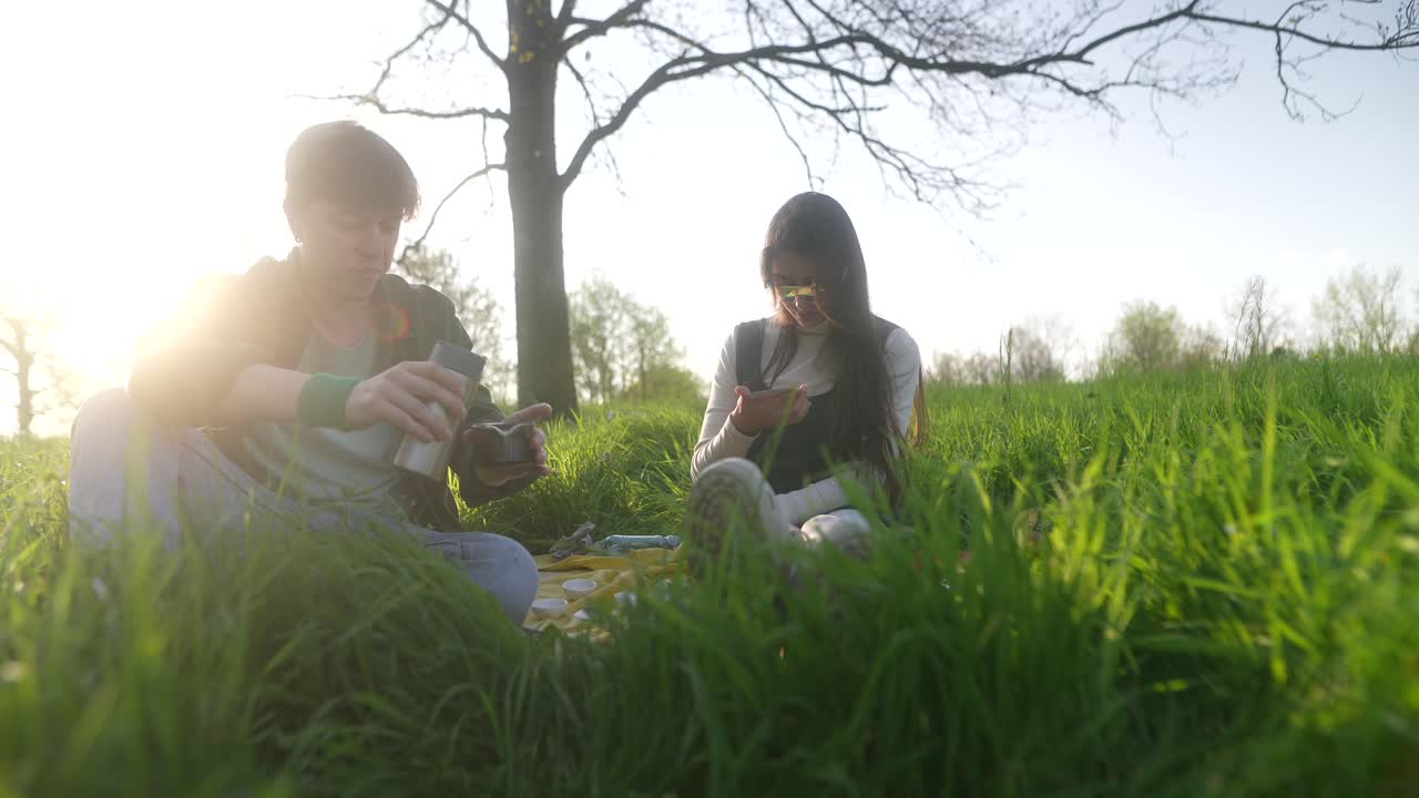 Couple Enjoying a Picnic in the Park at Sunset
