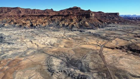 Rocky-hill-in-desert-valley-against-blue-sky-in-USA