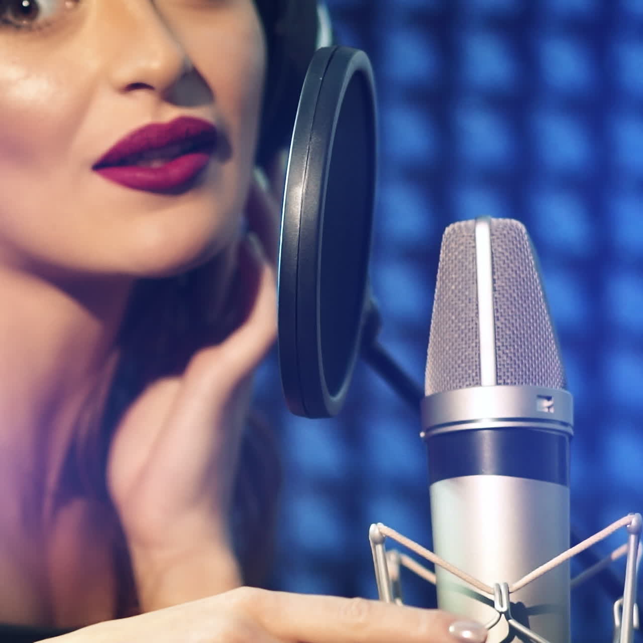 Beautiful young singer who recorded a song in a professional recording studio. Slow motion Square video