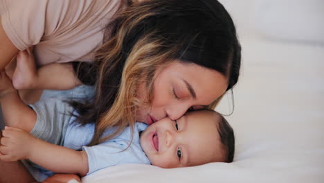 Happy,-kiss-and-baby-with-mom-in-bed-playing