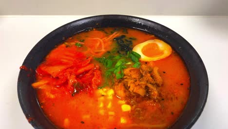 close up of different ingredients of miso ramen asian noodle soup handheld