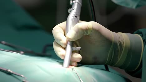 intricate surgical procedure: close-up of a surgeon’s hand using a surgical instrument on a patient during an operation