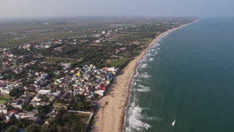 Aerial-Drone-Shot-of-Seashore-with-Buildings-And-Boats