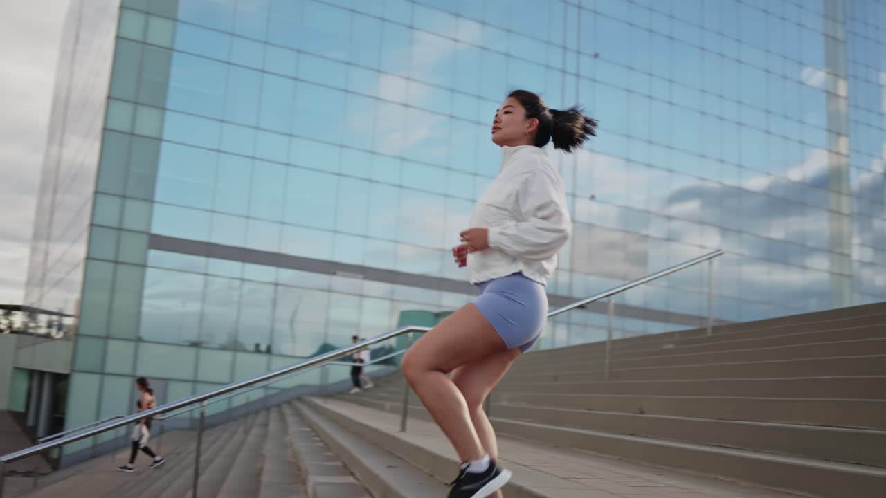 Young Woman Running Up Stairs in Urban Environment