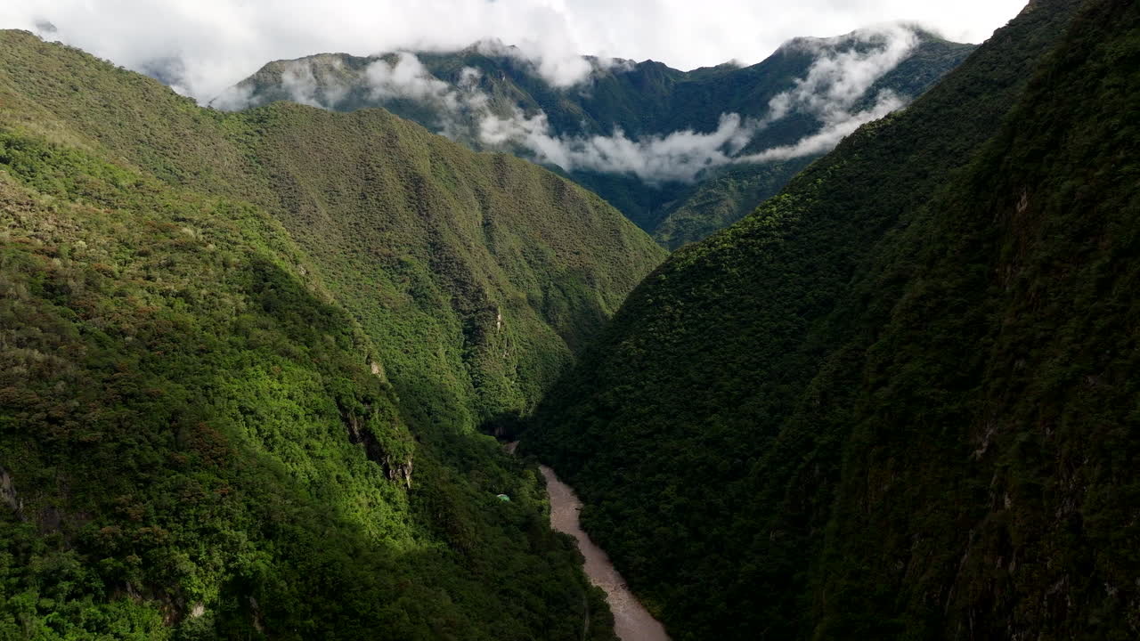 Urubamba river flows though lush mountainous valley near Aguas Calientes, drone
