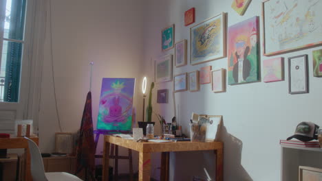art studio with workplace, painting supplies and artworks