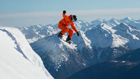 Snowboarder jumping over a snowy mountain landscape