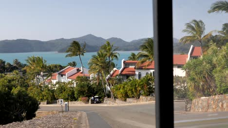 Stunning-tropical-view-of-white-stucco-terrace-housing-and-palm-trees-on-Hamilton-Island,-Queensland,-Australia