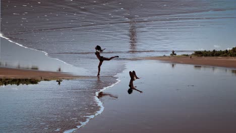 silhouette of joyful woman leaping by the seaside at sunset