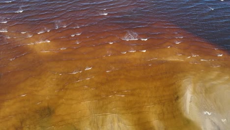 aerial view small sea waves wash the shore