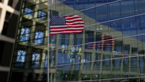 united states flag waving on a skyscraper building