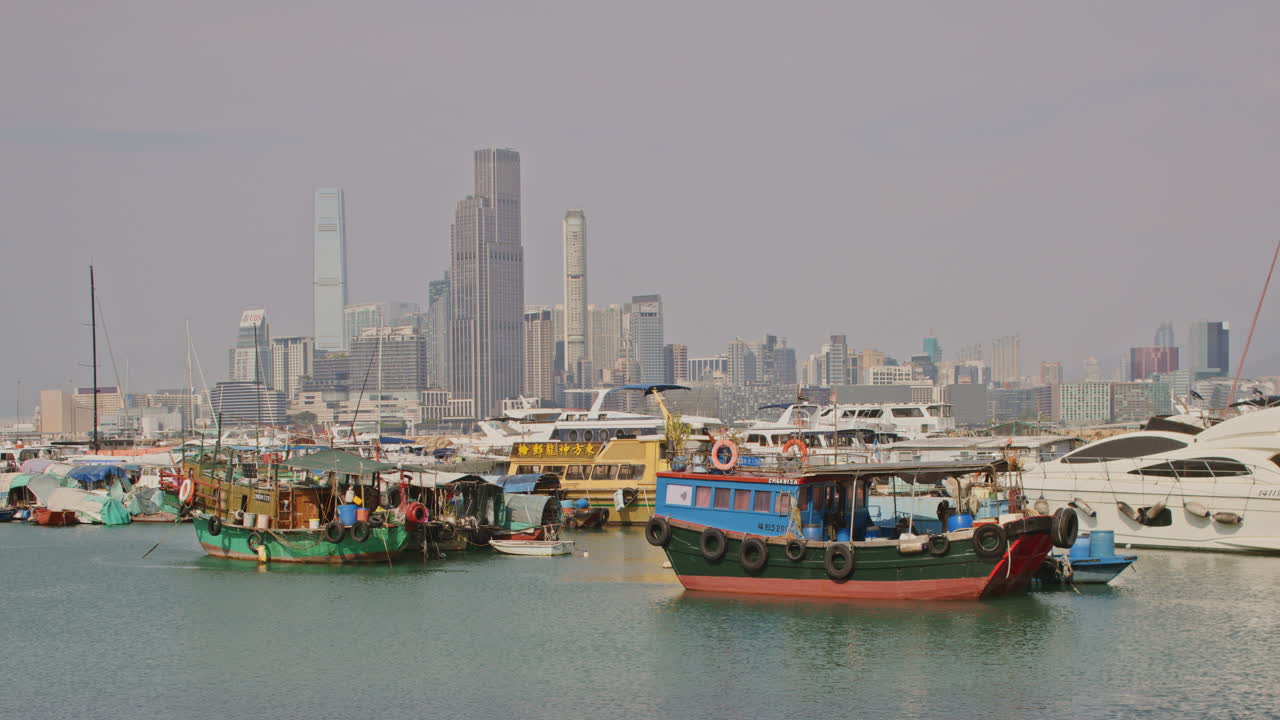 Boats Moored in Hong Kong Harbor with City Skyline in Background