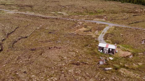 Drone-shot-of-a-moorland-shieling-and-a-wind-farm-on-the-Isle-of-Lewis