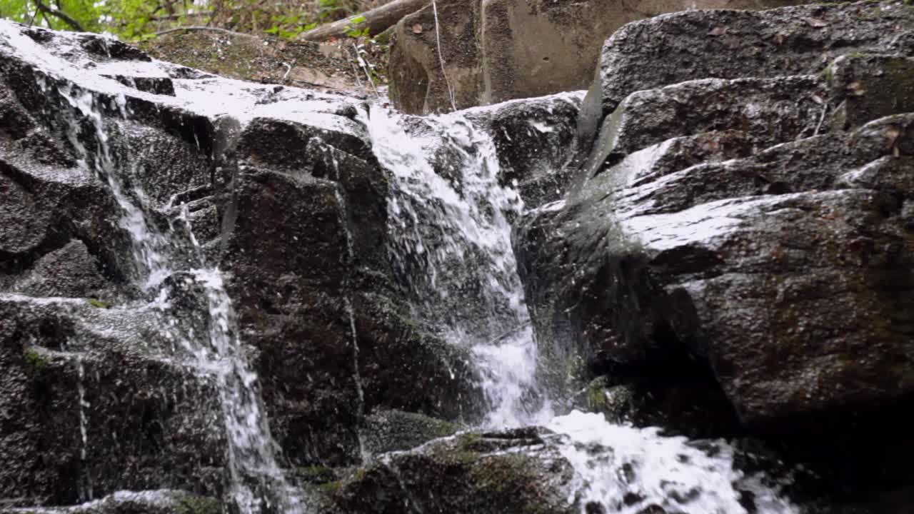 Beautiful water stream landscape. Waterfall flow on stone