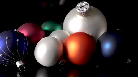 Pretty-and-colorful-glass-christmas-ornaments-on-black-surface