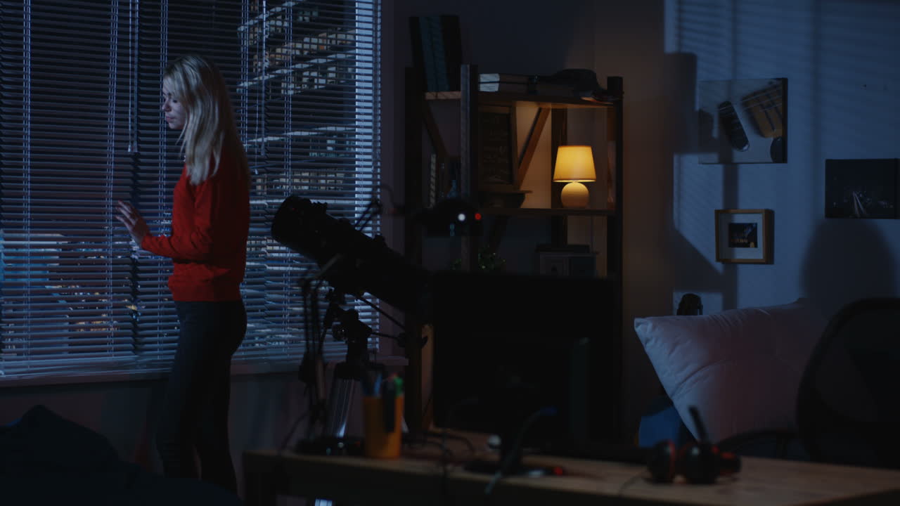 Woman looking out the window at night