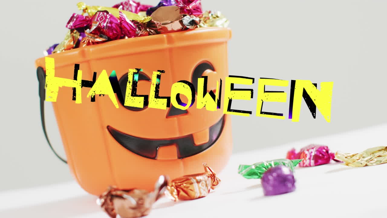 회색 배경에 과자와 함께 조각 된 호박 버 ⁇  위에 할로윈 텍스트의 애니메이션