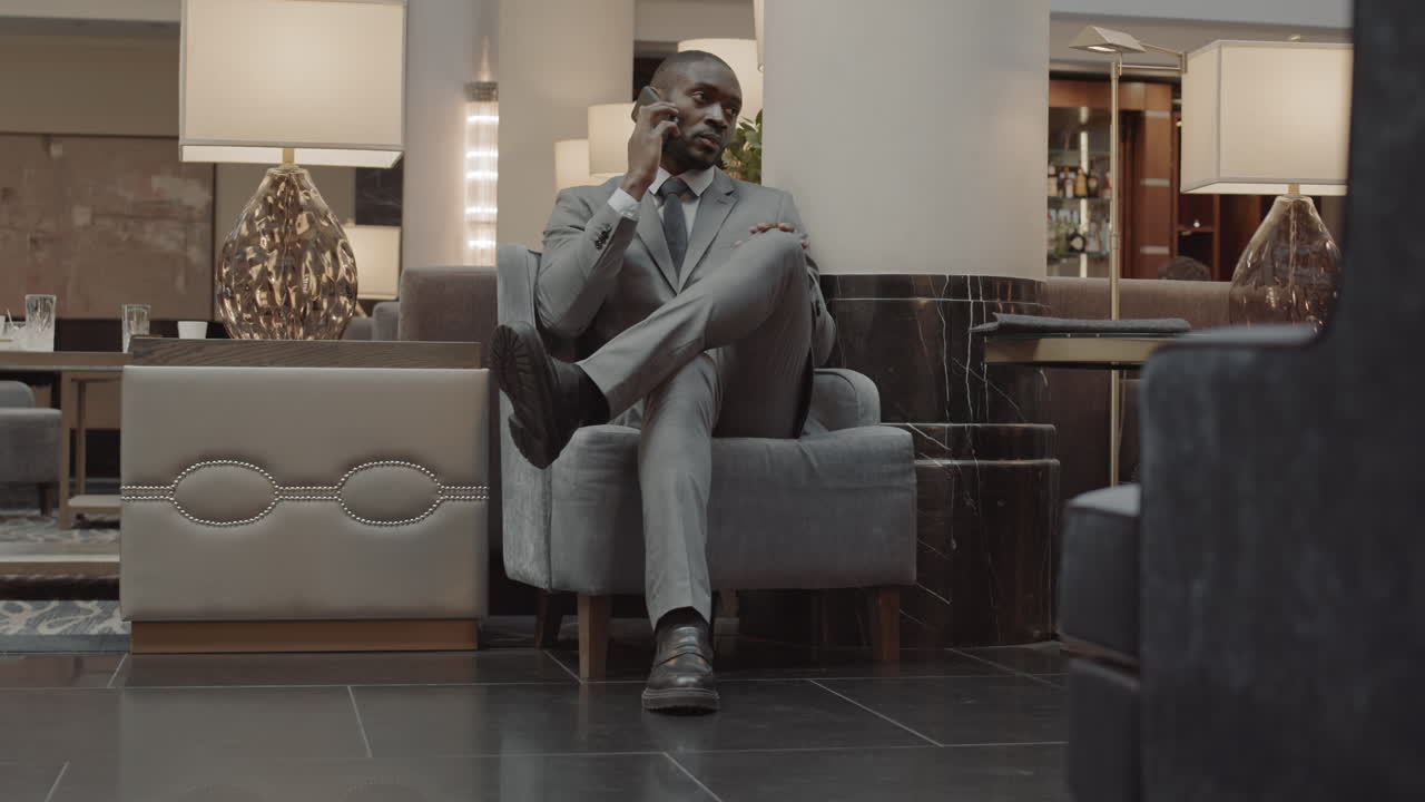 Businessman Calling in Luxury Hotel Lobby