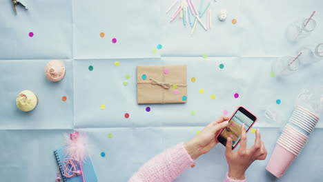 Top-view-woman-using-mobile-phone-present--Birthday-Party-planning-hands-from-above---Red-Epic-Dragon