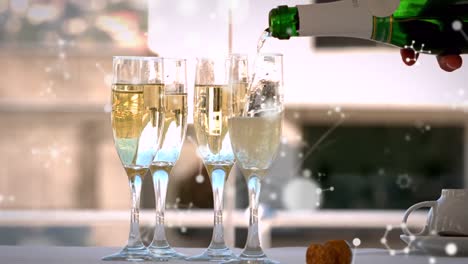 Animation-of-networks-moving-over-champagne-bottle-being-poured-into-four-glasses