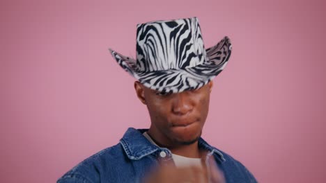 man wearing a zebra print cowboy hat