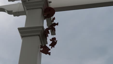 wind chimes on cloudy day ceramic on white pergola relaxing