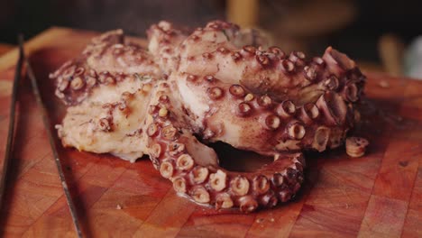 slow motion handheld shot around a freshly boiled soft bodied and eight legged molluscs octopus with piping hot steams