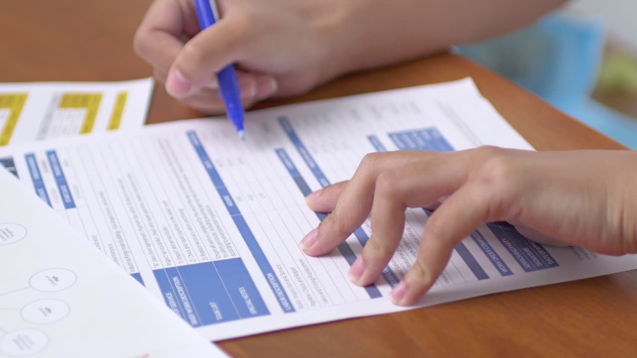 A student diligently fills important academic paperwork a bright classroom setting